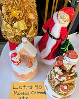All four holiday music boxes grouped on table