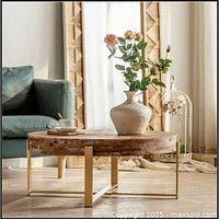 Full view of round wood coffee table staged in room
