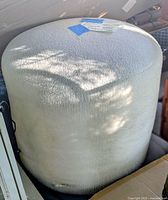 Full view of cylindrical white shag fabric stool