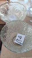 Two large clear cut glass bowls with note showing lot number