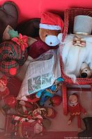 Storage bin with multiple vintage Christmas ornaments and miniatures