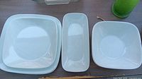 All eight white square/rectangular Corelle dishes laid out