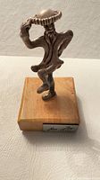 Front view of sterling silver fiddler on wooden base