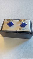 Front view of sterling silver lapis lazuli cufflinks in Kenneth Cole box