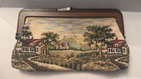 Front view of tapestry clutch showing full countryside scene and frame