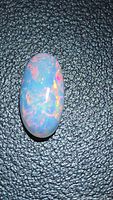 Front view of oval fire opal showing play of color