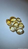 Seven golden citrine oval cabochons on white background