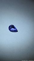 Pear-shaped violet-blue tanzanite front view