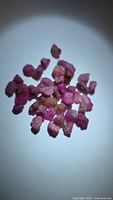 Group of rough ruby crystals under white light