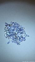 pile of small marquise tanzanite stones on white background