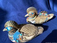Both brass cloisonné Mandarin duck figurines side by side
