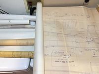 Multiple rolled plans with one unrolled showing Schweizer TG-3 glider drawing