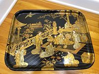 Full view of rectangular black lacquer papier-mâché tray with Japanese scene