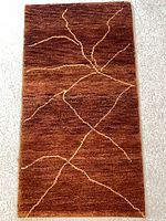 Full view of Gabbeh rug showing rust field and yellow linear design