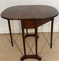 Full view of mahogany gateleg side table with leaves down