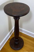 Full view of mahogany pedestal showing round top, fluted column and base
