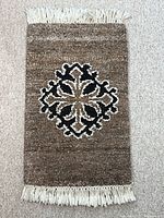Full view of mat showing design, fringe, and overall condition