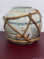 Frontal view of jar showing bamboo lashing and glaze
