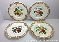 Group shot of four Royal Worcester gilt fruit plates