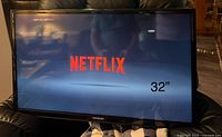 Front view of Samsung TV displaying Netflix logo and size indication