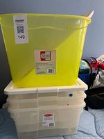 Stack of four bins: lime-green Get Sorted on top, three clear Rubbermaid below