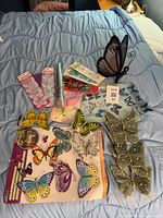 All items laid out including solar stake, decal sheets, lace appliqués, glitter butterflies, sequin roll, green ornament butterflies