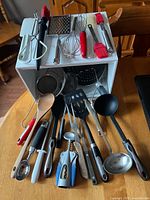 Full group of utensils displayed on and in front of white box
