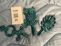 Three turquoise cast metal hooks with lot tag