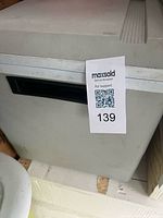 Front corner of Koolatron P75 cooler showing grey exterior and handle slot