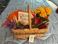 Full basket view with book, candles, flowers, potholder