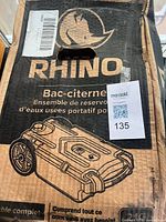 Front of sealed box showing Rhino branding and tank illustration