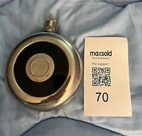 Front view of round stainless flask with cap visible