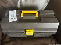 Closed plastic toolbox with yellow handle and latch