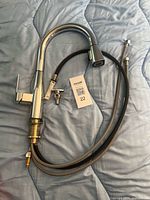 Full faucet with hose and mounting hardware displayed