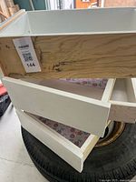 Stack of three white painted drawers showing interior and liner