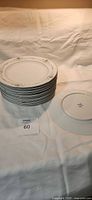Stack of ten dinner plates showing rim design