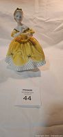 Front view of Royal Doulton figurine in yellow dress