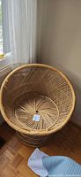 Front angled view of wicker rattan chair showing seat and weave pattern