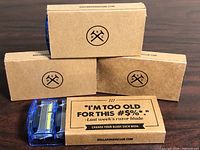 Three sealed Dollar Shave Club cardboard boxes and one open cartridge pack