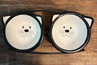 pair of cat face bowls on stand
