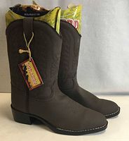 Side view of both brown faux-leather Durango youth western boots showing stitched shafts, tags attached