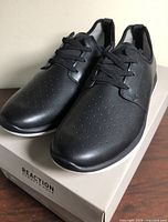 Front angle of both shoes on top of box