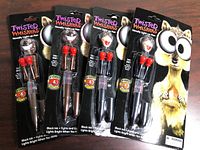 Four packaged Twisted Whiskers light-up pens on card backing