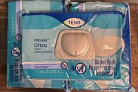 Front view of multiple sealed Tena ProSkin Ultra Wipes packs showing branding and flip-top lid