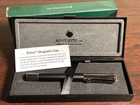 Pen in open presentation case with info card