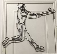 Full view of black metal wire baseball batter wall art on door