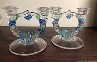 Full view of both glass double candlesticks on table