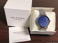 Watch in box with booklet and outer box showing brand