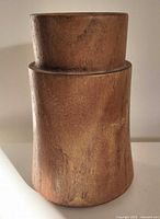 Front view of teak candle holder showing wood grain and shape