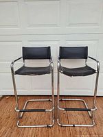 Two chrome cantilever bar stools front view